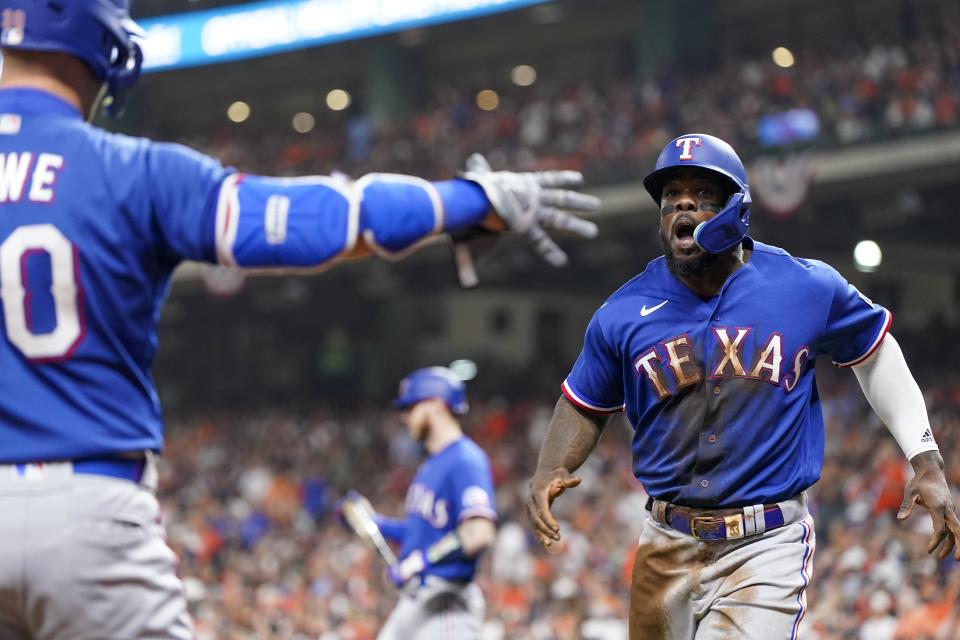 Texas Rangers' Adolis Garcia celebrates after scoring during the first inning of Game 6 of the baseball AL Championship Series against the Houston Astros Monday, Oct. 23, 2023, in Houston. (AP Photo/Godofredo A. Vásquez)