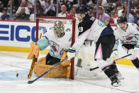 Atlantic Division's Matthew Tkachuk, of the Florida Panthers (19) works against Central Division's goaltender Juuse Saros, of the Nashville Predators (74) during the NHL All Star hockey game, Saturday, Feb. 4, 2023, in Sunrise, Fla. (AP Photo/Lynne Sladky)