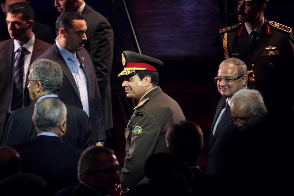 In this Thursday, March 14, 2014 photo, Egypt's Defense Minister, Field Marshal Abdel-Fattah el-Sissi, center, attends a gala event at the Cairo Opera House. Earlier in the day, the former chief of staff of the Egyptian armed forces, Gen. Sami Anan, declared that he would not run for president, as the public had anticipated. The announcement leaves a leftist politician as the only serious candidate to run against the nation's military chief, Field Marshal Abdel-Fattah el-Sissi, in the vote, expected in April. (AP Photo/Ahmed Omar)