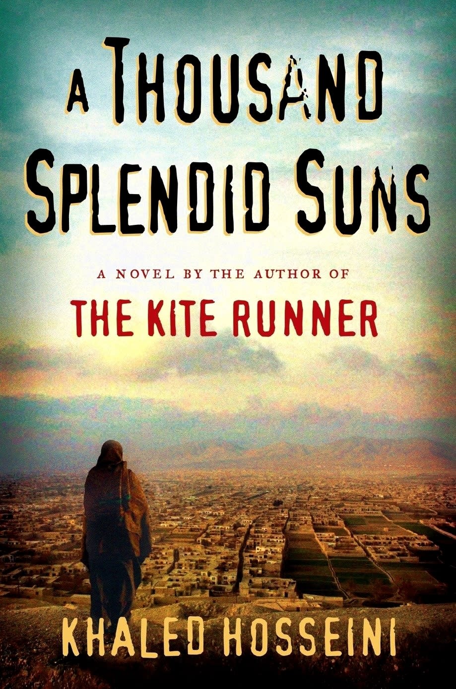 Book cover of "A Thousand Splendid Suns" by Khaled Hosseini, featuring a silhouette of a person walking towards a cityscape