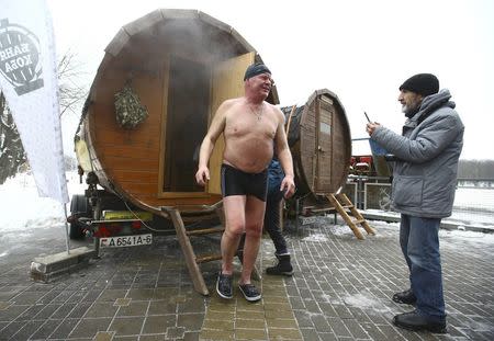 FILE PHOTO: A man leaves a sauna during the Belarusian winter swimming championship in Minsk, Belarus December 18, 2016. REUTERS/Vasily Fedosenko/File Photo