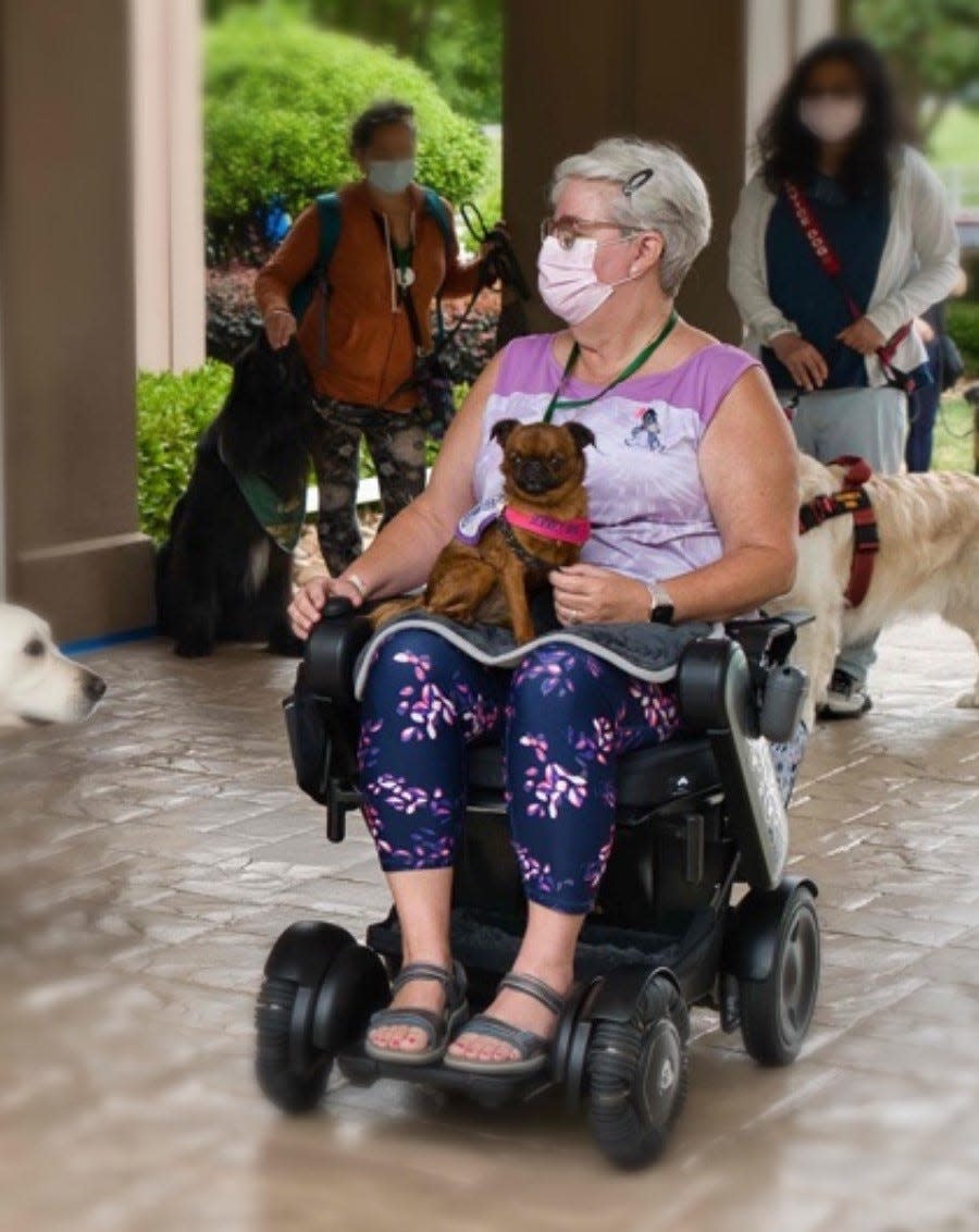 Karin Strickland with her service dog.