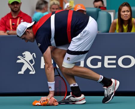 Mar 31, 2019; Miami Gardens, FL, USA; John Isner of the United States suffers an apparent injury in a match against Roger Federer of Switzerland (not pictured) during the men's finals at Miami Open Tennis Complex. Steve Mitchell-USA TODAY Sports