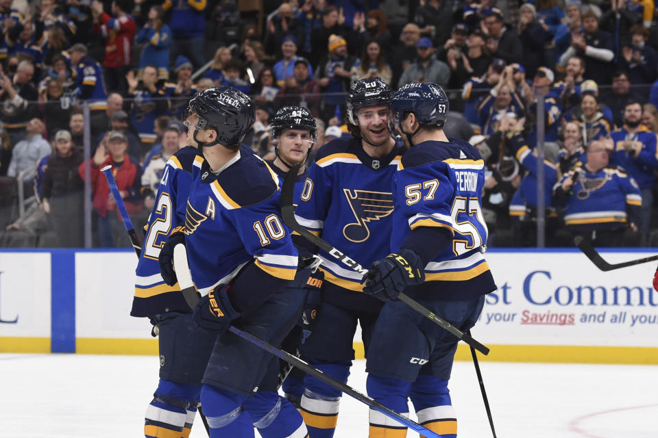 St. Louis Blues left wing Brandon Saad (20) is congratulated after scoring a goal against the Calgary Flames during the second period of an NHL hockey game Thursday, Jan. 27, 2022, in St. Louis. (AP Photo/Joe Puetz)