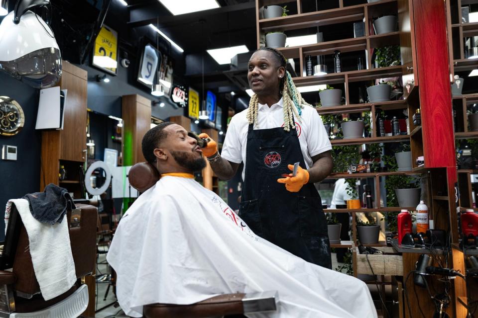 Celebrity barber Sheldon Edwards, pictured cutting the hair of England cricketer Chris Jordan, at his south London shop, HD Cutz (Daniel Hambury/Stella Pictures Ltd)