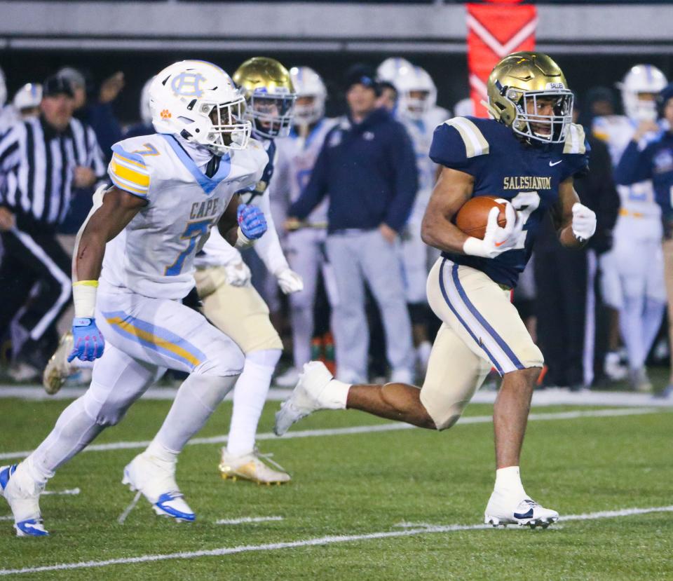 Salesianum's B.J. Alleyne (right) gets past Cape Henlopen's Maurki James on the way to his third touchdown of the game during the Sals' 45-17 win in the DIAA Class 3A state championship at Delaware Stadium last Friday.