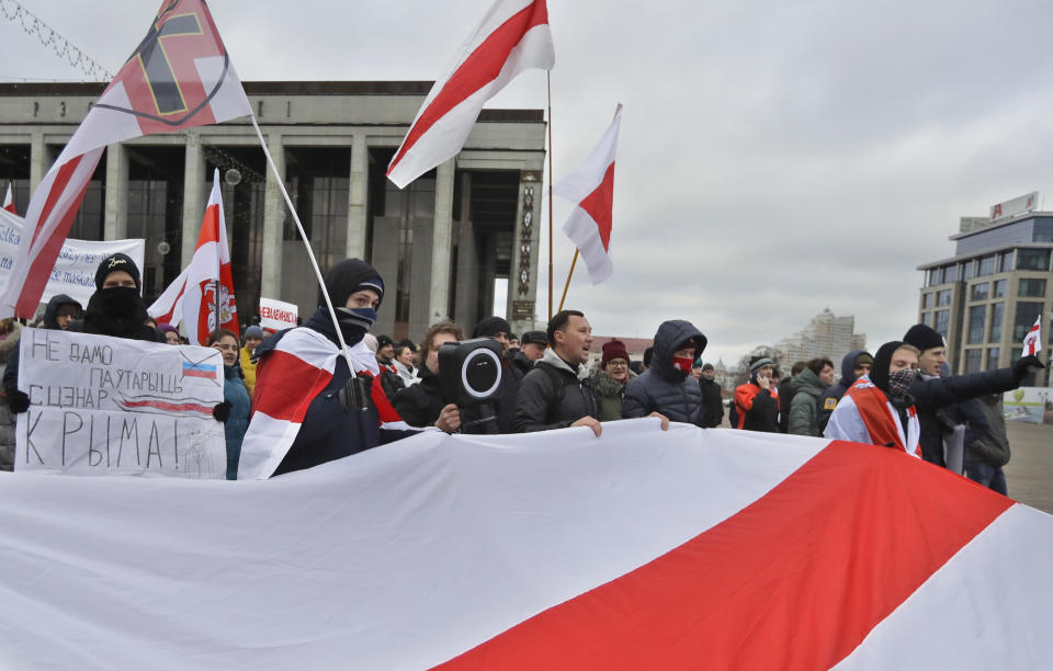 Protesters attend a procession in downtown Minsk, Belarus, Sunday, Dec. 8, 2019. A rally was held to protest closer integration with Russia which protesters fear could erode the post-Soviet independence of Belarus, a nation of 10 million. (AP Photo/Sergei Grits)