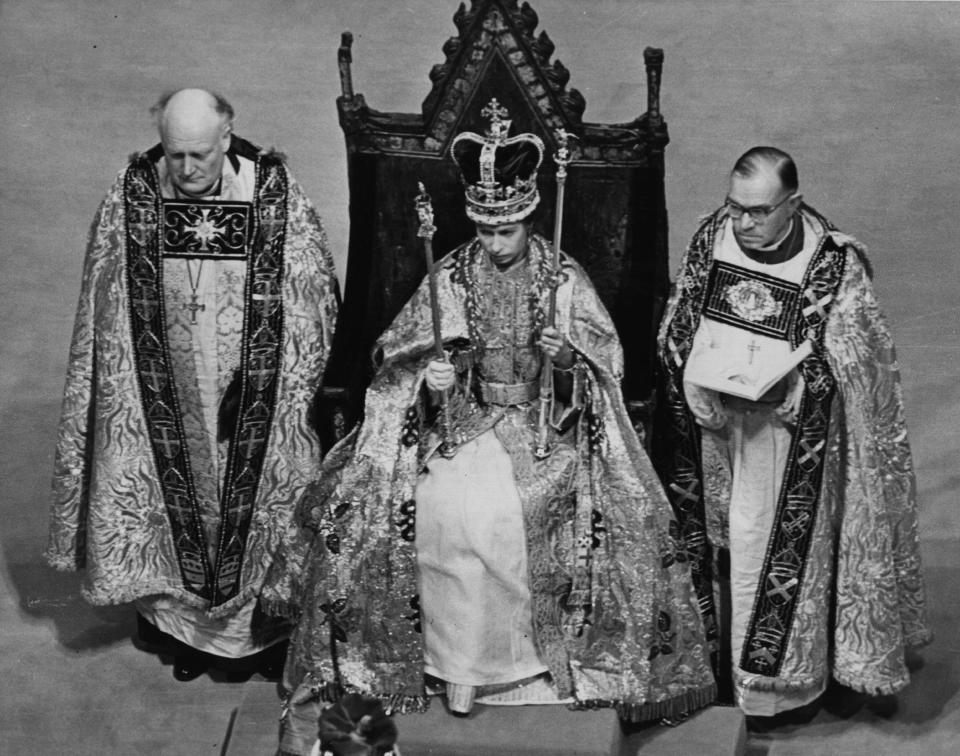 Queen Elizabeth II holding her symbols of office after the crowning ceremony at her coronation on June 2, 1953. / Credit: / Getty Images