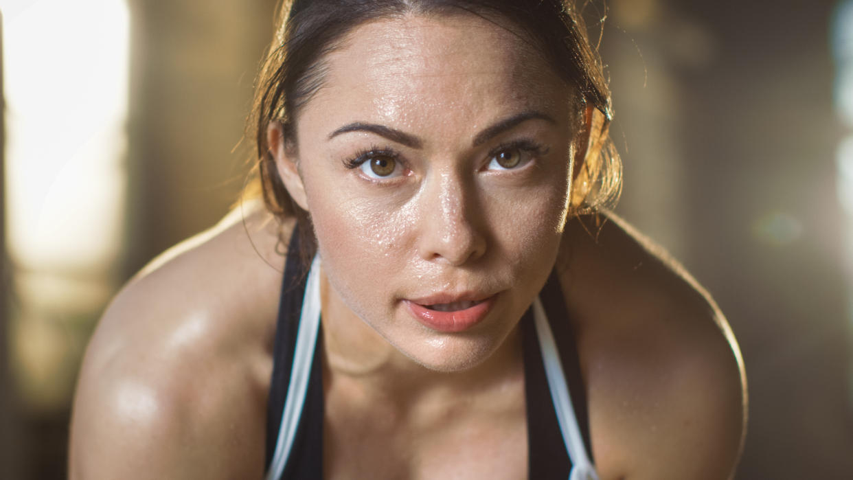  Close-up of woman's face covered in sweat 