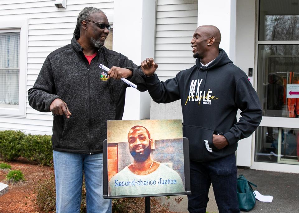 Thurston Allen, father of William Allen, elbow-bumps New England Patriots safety Devin McCourty after the news conference calling for commutation of William Allen’s life sentence in prison on Wednesday, April 7, 2021, outside the Christ Congregational Church in Brockton.