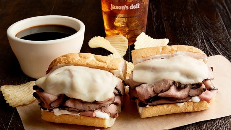 A French dip sandwich with au jus, chips and iced tea