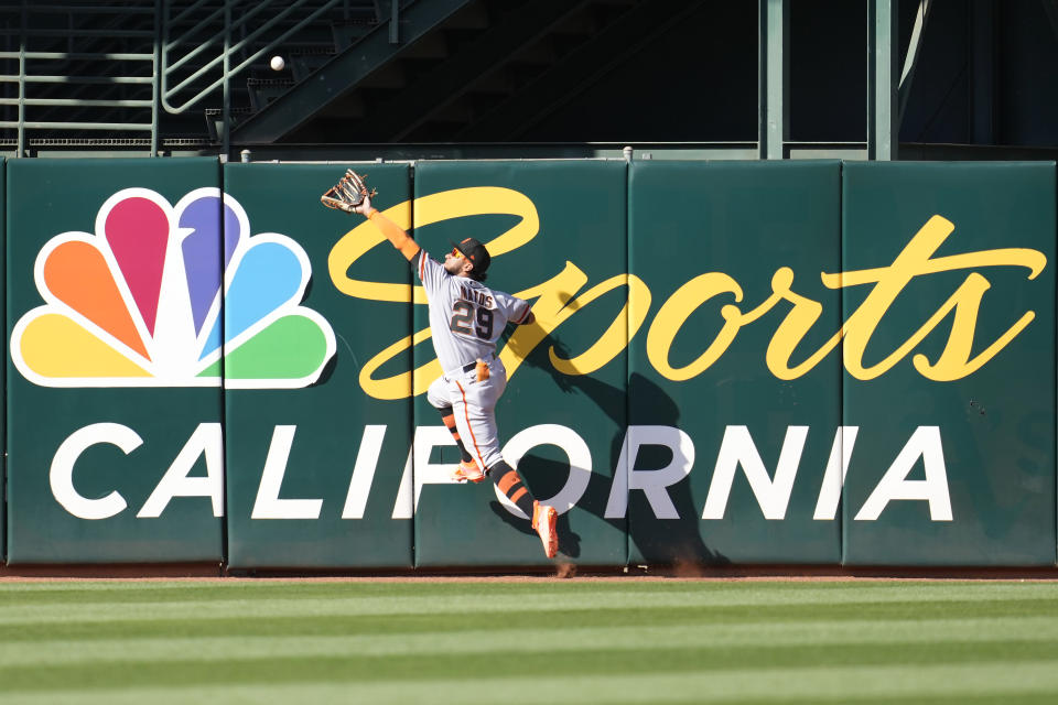 San Francisco Giants center fielder Luis Matos (29) jumps up to catch a fly out at the wall hit by Oakland Athletics' Seth Brown during the fourth inning of a baseball game in Oakland, Calif., Saturday, Aug. 5, 2023. (AP Photo/Jeff Chiu)