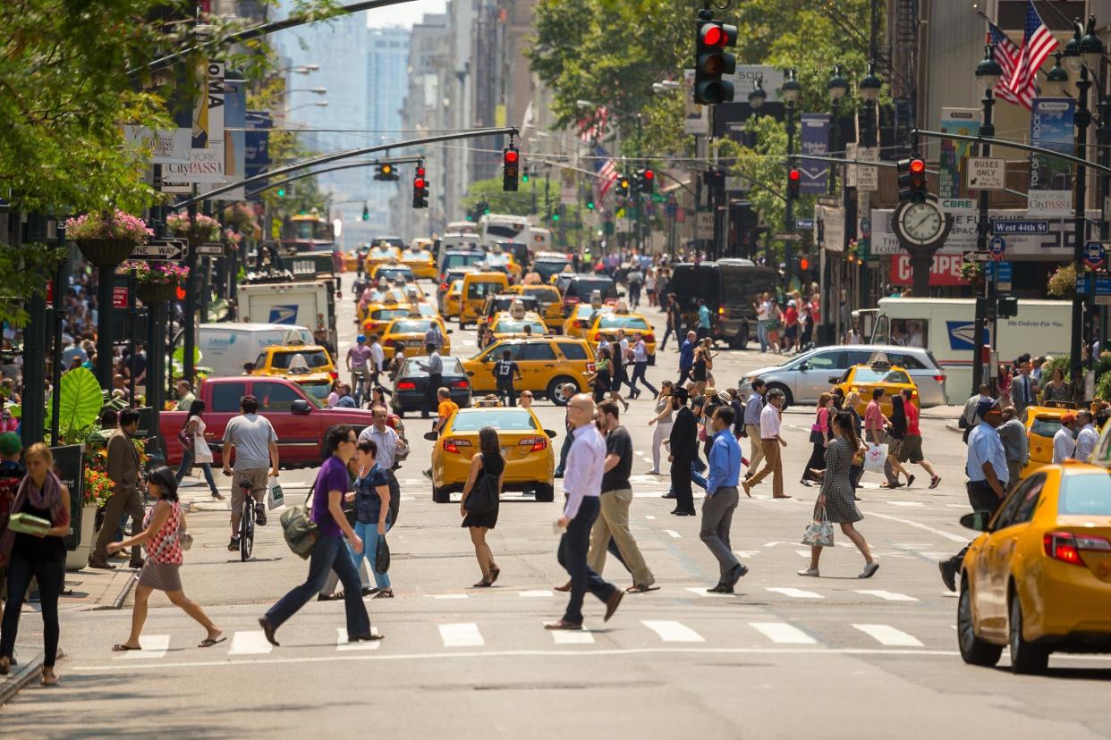 crowd of people pedestrians walking crossing street in NYC