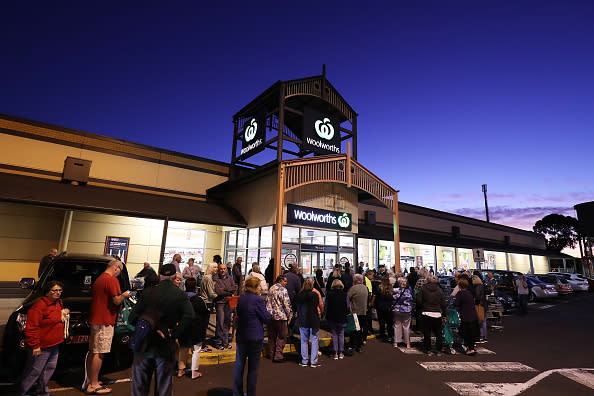 General view outside a Woolworths in Sunbury as people wait outside during sunrise.