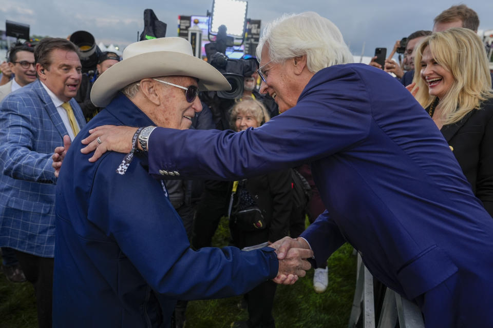 Seize The Grey's trainer D. Wayne Lukas, left, shakes hands with with Bob Baffert, Imagination's trainer, after Lukas' horse won the Preakness Stakes horse race at Pimlico Race Course, Saturday, May 18, 2024, in Baltimore. (AP Photo/Julia Nikhinson)