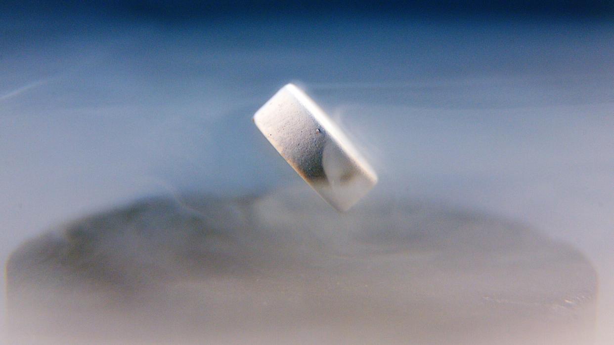  A superconductor floats above a magnet. 