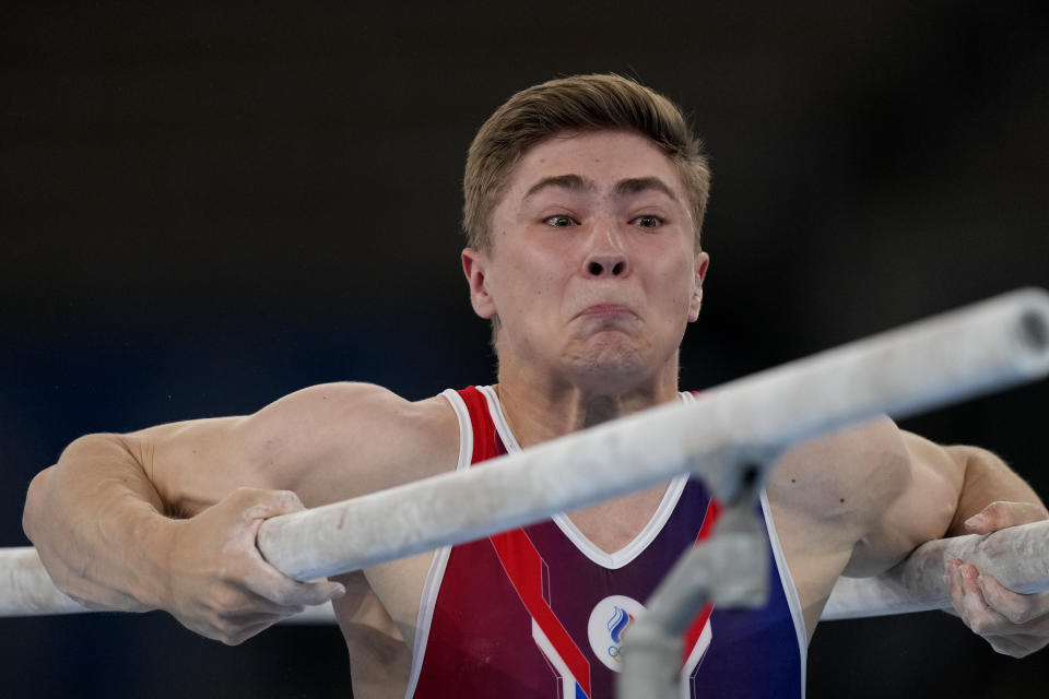 The Russian Olympic Committee's Aleksandr Kartsev performs on the parallel bars during the men's artistic gymnastic qualifications at the 2020 Summer Olympics, Saturday, July 24, 2021, in Tokyo. (AP Photo/Natacha Pisarenko)