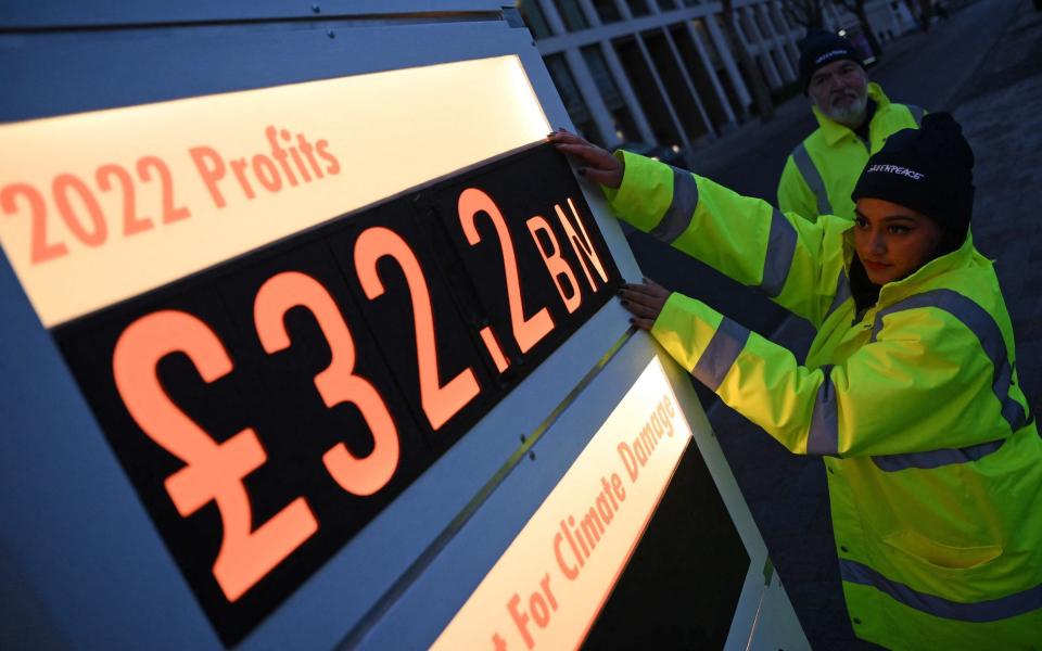 Activists from Greenpeace set up a mock-petrol station price board outside its London headquarters - DANIEL LEAL/AFP via Getty Images