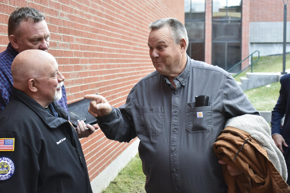 Sen. Jon Tester, D-Mont., thanks Butte-Silver Bow Sheriff Ed Lester for providing security during a town hall hosted by the Democratic lawmaker at Montana Technological University, Nov. 10, 2023, in Butte, Mont. Tester is seeking re-election to a fourth term. (AP Photo/Matthew Brown)