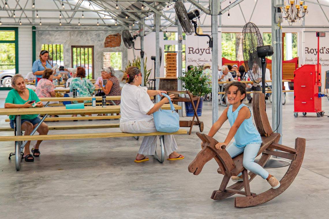 A customer rides a rocking horse in the children’s play area as people enjoy the atmosphere at Royd’s.