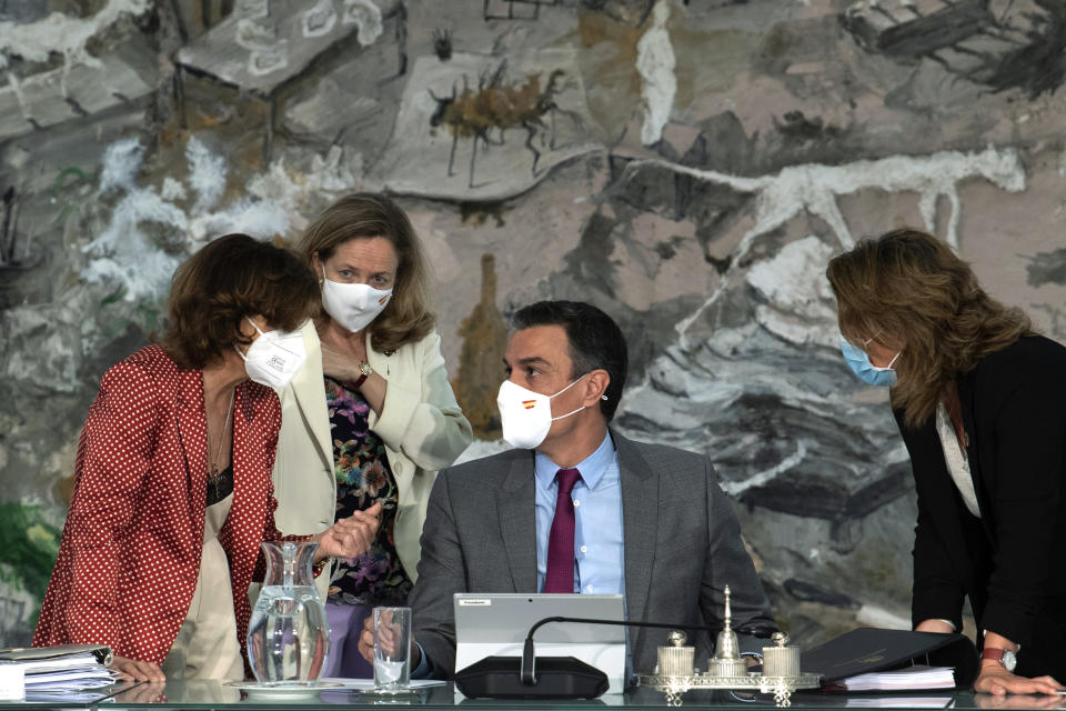 FILE - In this photo provided by the Spanish Government in Madrid on Tuesday June 22, 2021, Spain's Prime Minister Pedro Sanchez, centre, talks with Spain's Deputy Prime Minister Carmen Calvo, left, Spain's Deputy Prime Minister and Minister of Economic Affairs Nadia Calvino, 2nd left and Spain's Deputy Prime Minister and Minister of Ecological Transition and Demographic Challenge Teresa Ribera during a cabinet meeting at the Moncloa Palace in Madrid, Spain. Prime Minister Pedro Sanchez has overhauled his Cabinet to form what he calls "the government of the recovery" following the coronavirus pandemic.The biggest change was the exit of Carmen Calvo, Sanchez's right hand as the top-ranked deputy prime minister. Economy Minister Nadia Calvino was elevated to take her place. (Borja Puig de la Bellacasa/Spanish Government via AP, File)