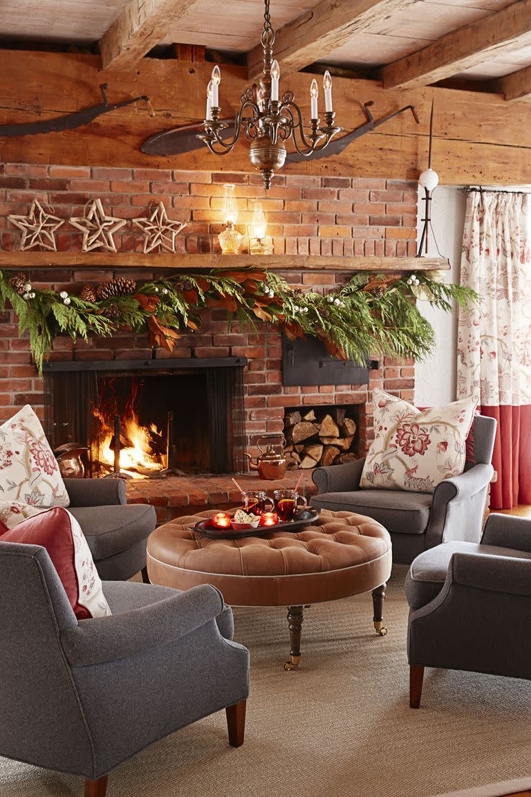 <p>Lean on fresh greens to bring the drama to the hearth of your home: the fireplace. For a bolder statement, sprinkle in a mix of pinecones, ribbons, and berries. </p>
