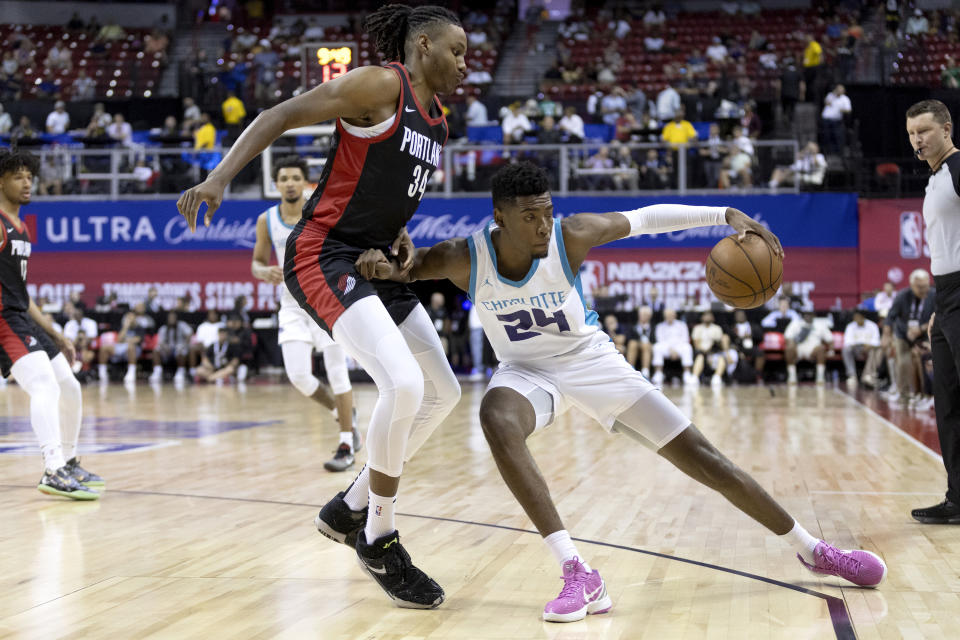 Charlotte Hornets forward Brandon Miller (24) dribbles around Portland Trail Blazers forward Jabari Walker (34) during an NBA summer league basketball game Tuesday, July 11, 2023, in Las Vegas. (Ellen Schmidt/Las Vegas Review-Journal via AP)