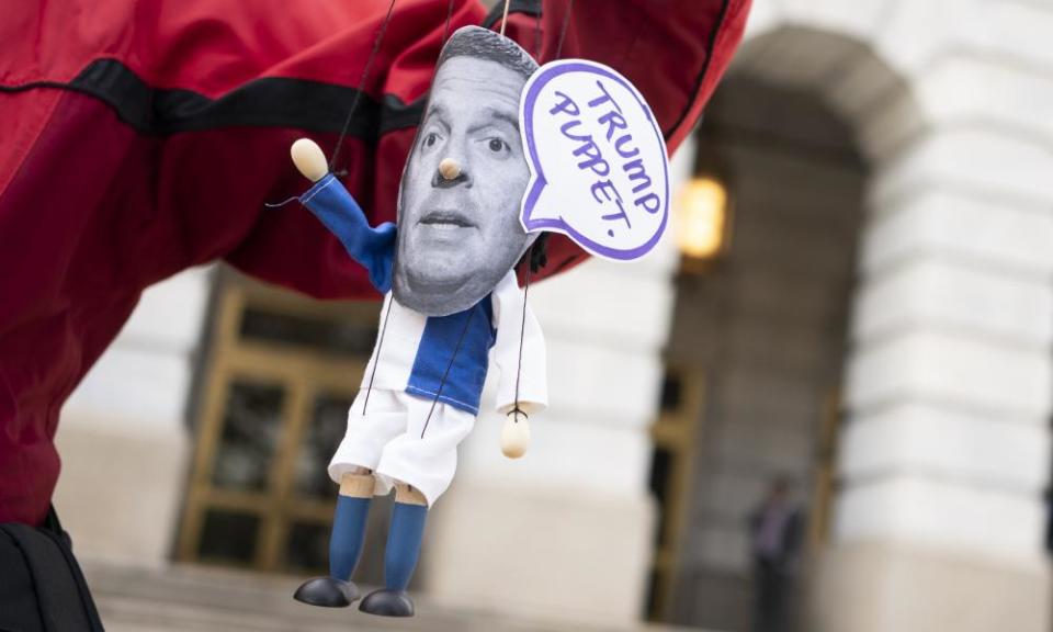 A demonstrator holds a homemade puppet of Devin Nunes during the impeachment inquiry of Donald Trump.