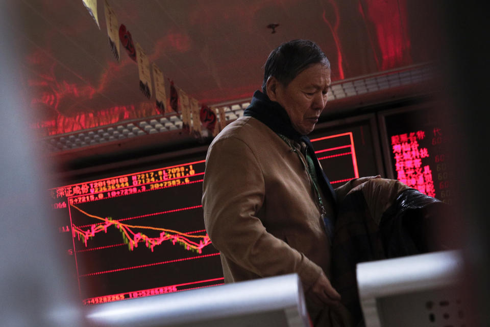 A man prepares to leave the brokerage house in Beijing, Thursday, Jan. 3, 2019. Asian markets were mostly higher Thursday after tumbling more than 1 percent on the first trading day of 2019, as weaker-than-expected Chinese data exacerbated growth fears. (AP Photo/Andy Wong)