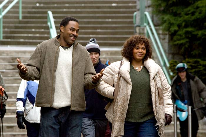 Lamman Rucker and Jill Scott walking together while having a conversation in "Why Did I Get Married?"