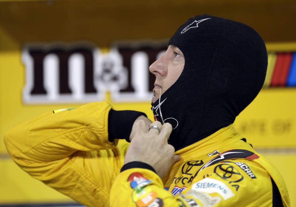 Kyle Busch prepares to get into his car during qualifying for the NASCAR Cup Series auto race at Homestead-Miami Speedway, Friday, Nov. 16, 2018, in Homestead, Fla. (AP Photo/Lynne Sladky)