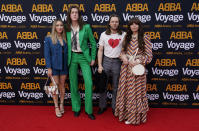 Members of the band Blossoms, centre right and center left, arrive for the ABBA Voyage concert at the ABBA Arena in London, Thursday May 26, 2022. ABBA is releasing its first new music in four decades, along with a concert performance that will see the "Dancing Queen" quartet going entirely digital. The virtual version of the band will begin a series of concerts on Thursday. (AP Photo/Alberto Pezzali)