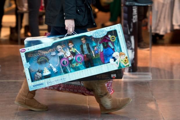 Disney announced in March that it planned to close 60 locations across North America this year, but had no specific comment on its Canadian locations. Now it appears as though all Canadian locations will be closed by next month. In this picture, a shopper carries Disney's Frozen dolls sets as she walks through the Trafford Centre shopping mall past retailers offering Black Friday discounts in Manchester, northern England on Nov. 27, 2015.  ( - image credit)