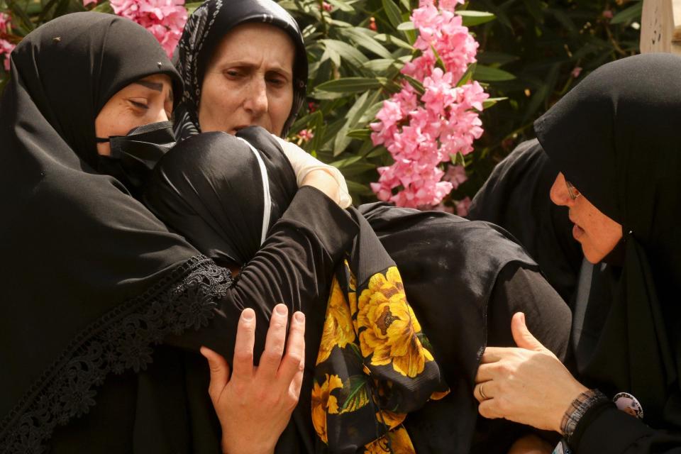 The mother (centre) of Aya as she mourns during her daughters funeral in the southern Lebanese town of Qlaile (AFP via Getty Images)