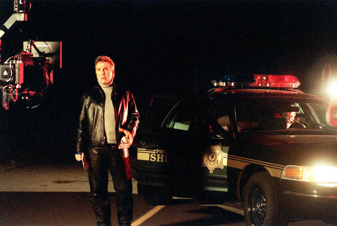 John Walsh speaks into the camera while shooting the opening to the television show COPS at the Pierce County Airport Thursday, October 26, 2000.(Janet Jensen/The News Tribune)