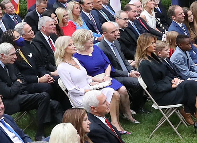 <div class="inline-image__caption"><p>Trish Scalia (blue dress) sat next to Kellyanne Conway, who also got the coronavirus, and behind Melania Trump, who also tested positive.</p></div> <div class="inline-image__credit">Chip Somodevilla/Getty</div>