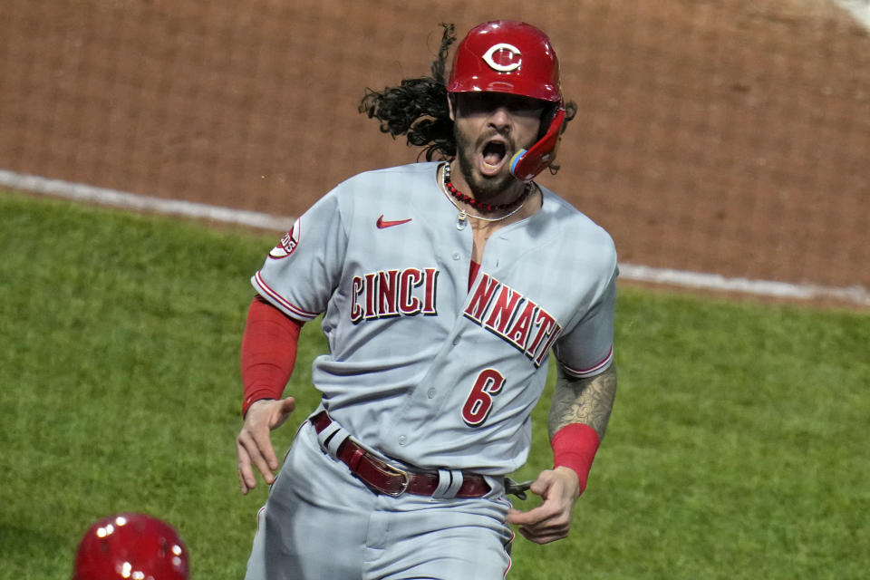 Cincinnati Reds' Jonathan India celebrates as he returns to the dugout after scoring on a double by Stuart Fairchild off Pittsburgh Pirates starting pitcher Rich Hill during the fifth inning of a baseball game in Pittsburgh, Saturday, April 22, 2023. (AP Photo/Gene J. Puskar)