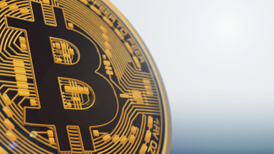An up-close look at a physical gold bitcoin token.
