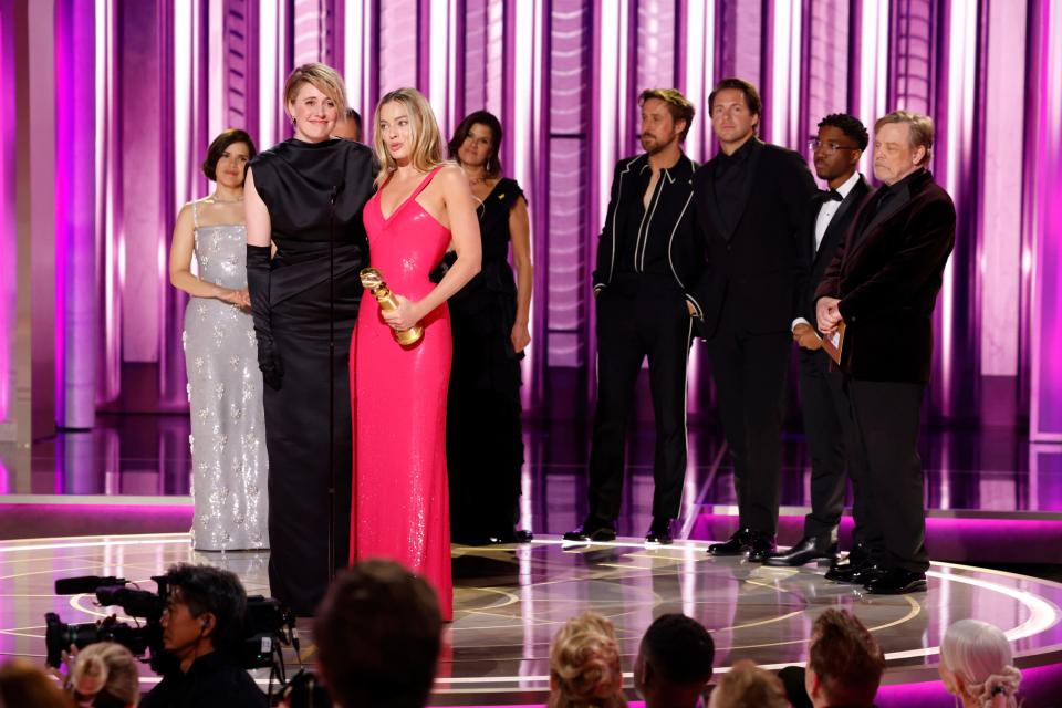 Greta Gerwig and Margot Robbie accept the award for cinematic and box office achievement for "Barbie."