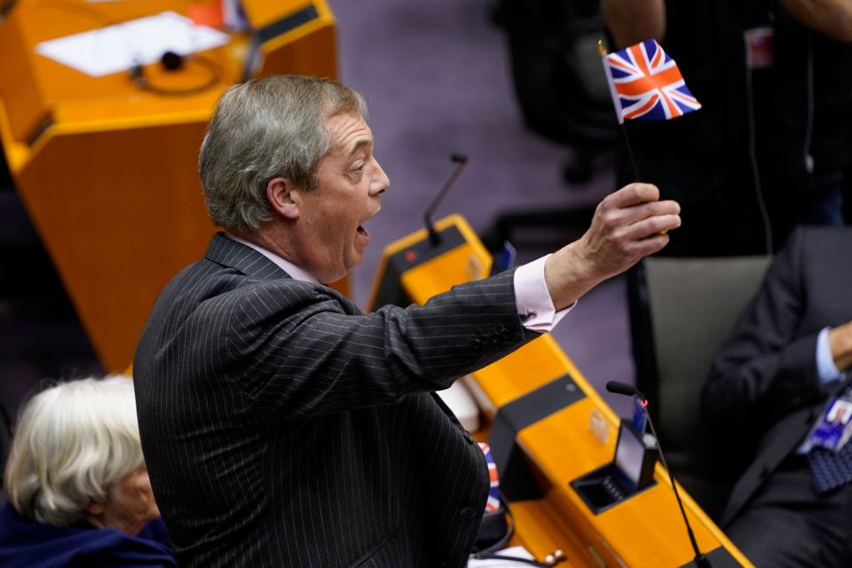 Britain's Brexit Party leader Nigel Farage (C)  waves a union flag  during a European Parliament plenary session in Brussels on January 29, 2020, as Brexit Day is to be set in stone when the European Parliament casts a vote ratifying the terms of Britain's divorce deal from the EU. (Photo by Kenzo TRIBOUILLARD / AFP) (Photo by KENZO TRIBOUILLARD/AFP via Getty Images)