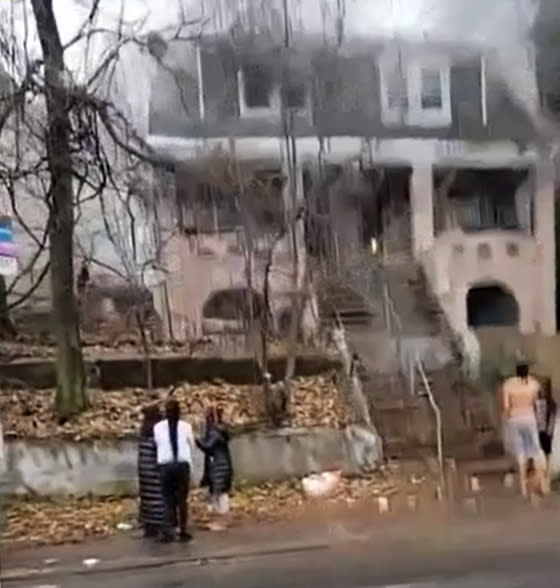People stand outside a house fire Friday morning in New York City's Staten Island (Citizen App / via NBC4)