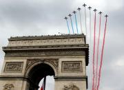 French military jets fly over the Arc de Triomphe in Paris during the annual Bastille Day military parade on July 14, 2014