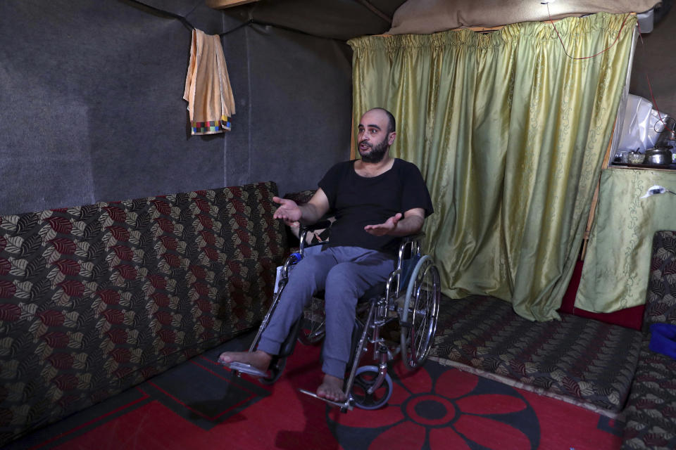 In this Sunday, June 16, 2019 photo, Abu Abdou, 38, a Syrian refugee speaks during an interview with The Associated Press inside his tent in a refugee camp in the eastern Lebanese border town of Arsal, Lebanon. Authorities in Lebanon are waging their most aggressive campaign yet against Syrian refugees, making heated calls for them to go back to their country and taking action to ensure they can’t put down roots. They are shutting down shops where Syrians work without permits and ordering the demolition of anything in their squalid camps that could be a permanent home. (AP Photo/Bilal Hussein)