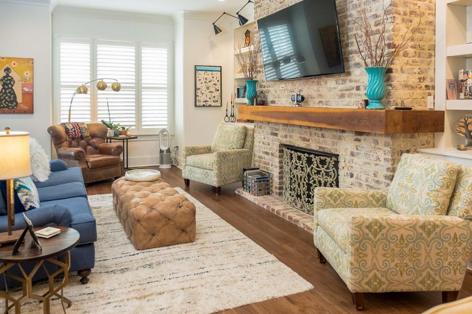 Plenty of comfortable seating, a fireplace, and a big screen television truly make this living room a place built for relaxation.