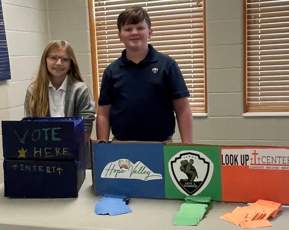 Blessed Sacrament School fifth graders Mia Richards and Dylan Donaldson gave the student body three options for their Romans 12 fundraiser: Hope Valley, Save A Warrior and the Look Up Center. The students chose Save A Warrior and they raised $947.84 for the program.