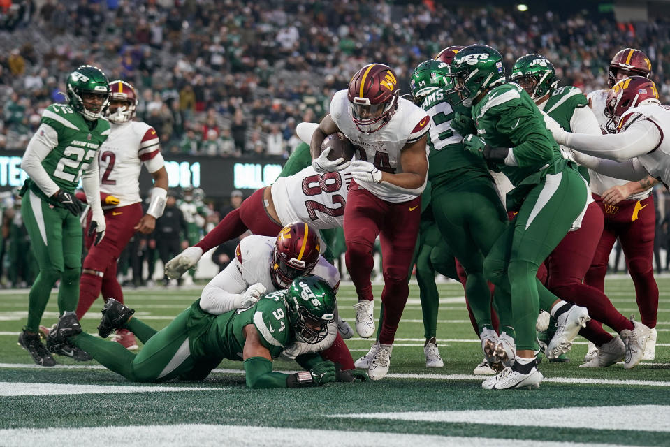 Washington Commanders running back Antonio Gibson (24) crosses the goal line to score a touchdown against the New York Jets during the fourth quarter of an NFL football game, Sunday, Dec. 24, 2023, in East Rutherford, N.J. (AP Photo/Seth Wenig)