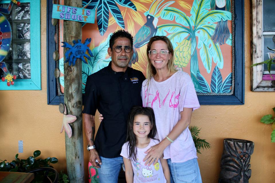 Chef Jorge Paz (left) smiles with his partner Tara Barnes (right) and their daughter, Luna, on May 29, 2024, at The Catch in Lake Park.