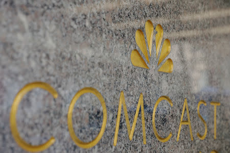 FILE PHOTO: The NBC and Comcast logos are displayed on 30 Rockefeller Plaza in midtown Manhattan in New York, U.S., February 27, 2018. REUTERS/Lucas Jackson/File Photo