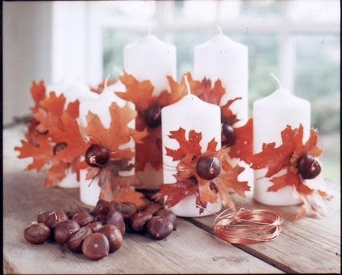 diy pillar candle gifts wrapped in copper wire accented with chestnuts and maple leaves