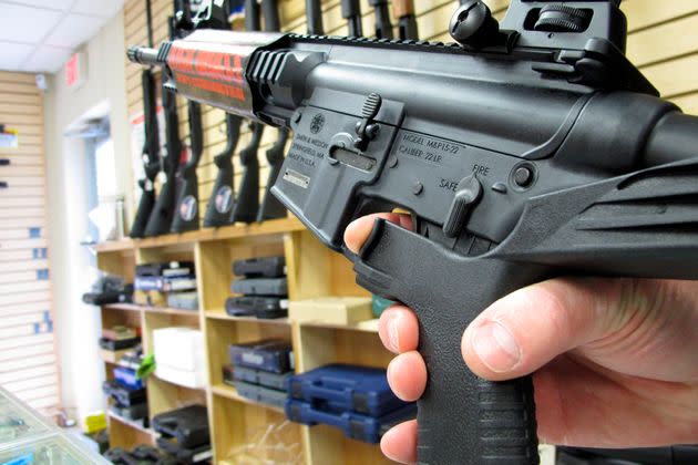 An employee of a gun store in Raleigh, North Carolina, demonstrates how a bump stock works on Feb.  1, 2013. The gun accessory makes semiautomatic weapons fire faster.